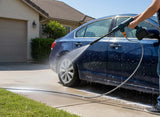 Cordless portable pressure washer by HOT PRICE, showcasing a sleek design and nozzle attachment in a clean outdoor setting.